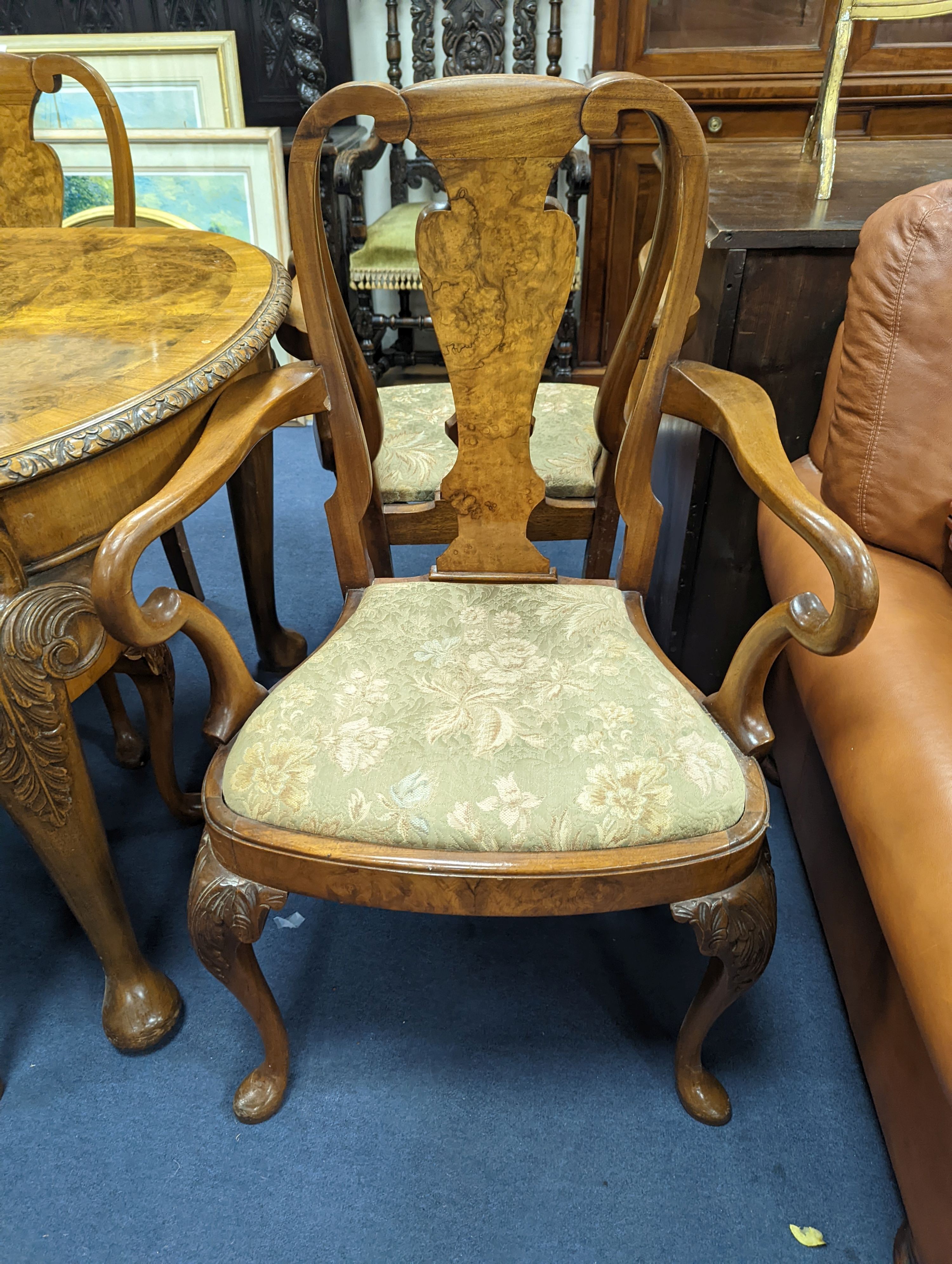 A Queen Anne revival burr walnut dining suite, comprising serpentine sideboard, length 168cm, depth 56cm, height 98cm, extending dining table, 210cm extended, one spare leaf, width 90cm, height 75cm and eight chairs, two